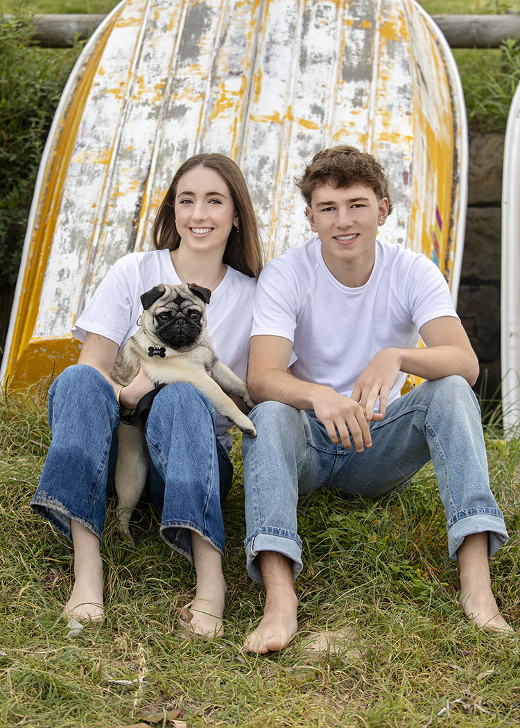 teenage children with their dog at beach